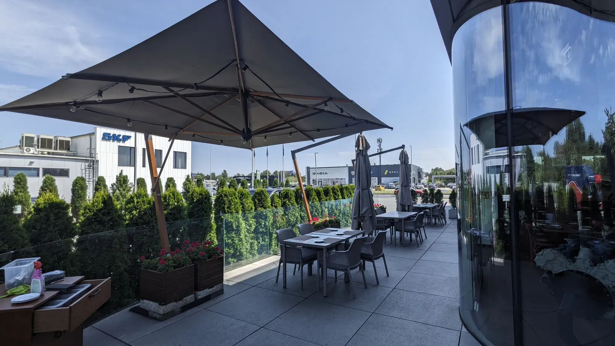 La Squadra restaurant terrace in Katowice, parasols over tables along the glazed facade