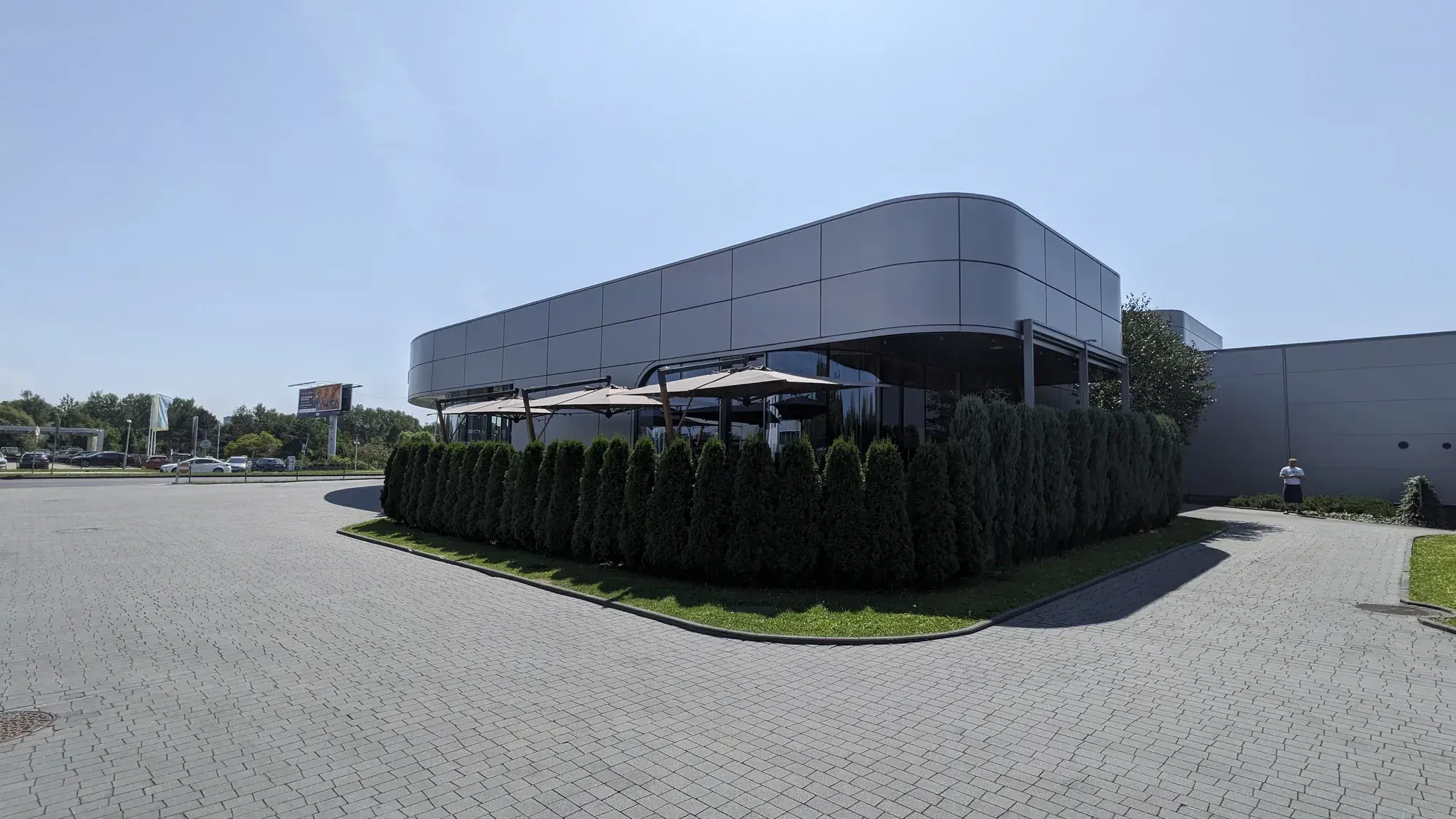 La Squadra restaurant and car showroom building with parasols on the terrace