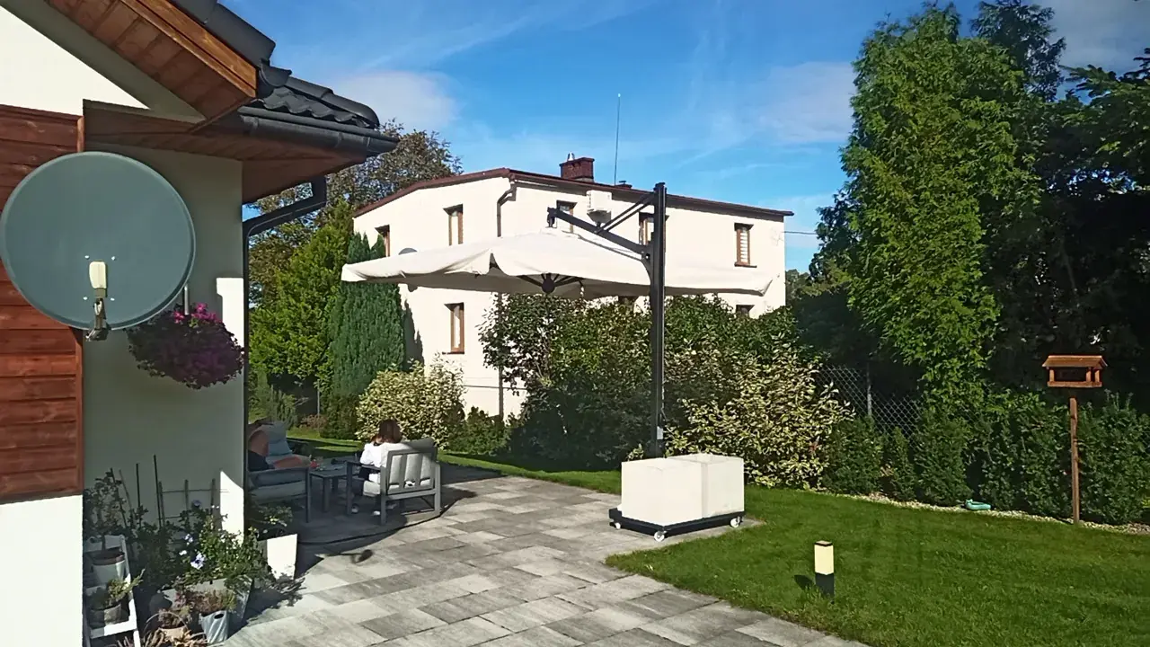Galileo Dark over the lawn and terrace by a house in Jaworze