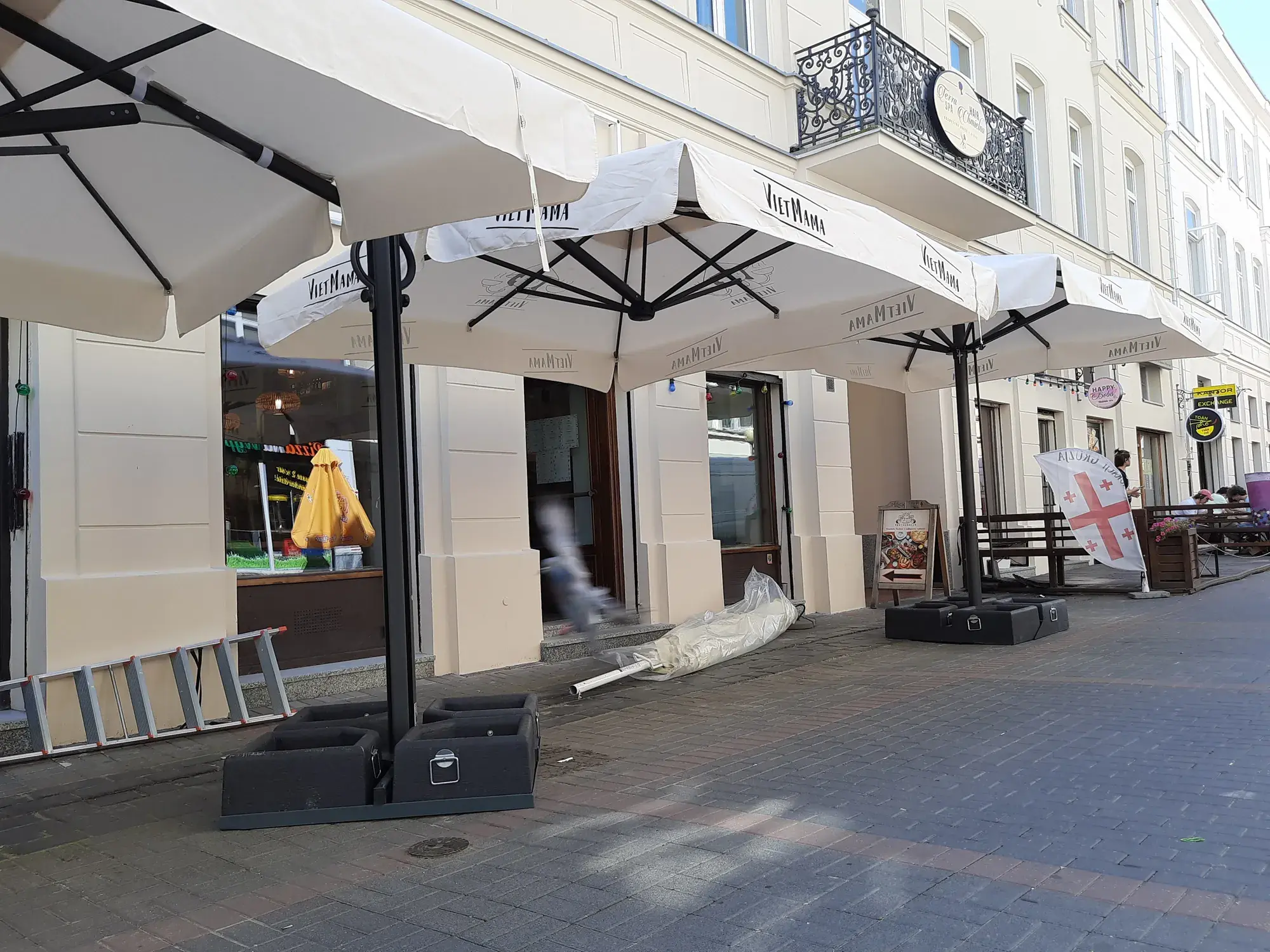 Open Galaxia Dual canopies over the pavement in front of Viet Mama restaurant