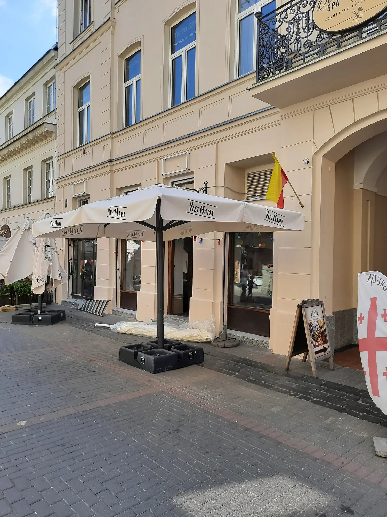 Capri parasol with the Viet Mama restaurant logo on the Chmielna pedestrian street
